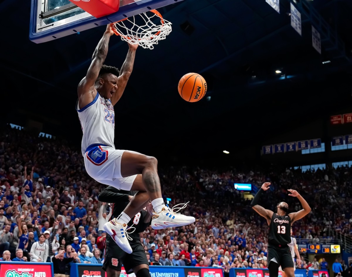 Kansas Jayhawks forward K.J. Adams Jr. (24) dunks the ball against Houston Cougars guard Mylik Wilson (8) during the second half at Allen Fieldhouse in Lawrence, Kansas, on. Feb. 3, 2024.